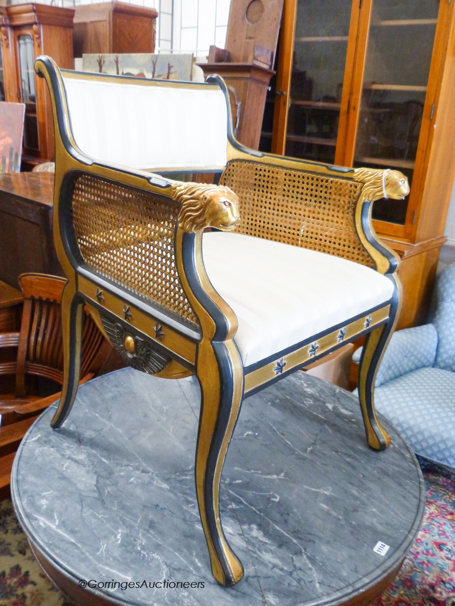 A parcel gilt ebonised elbow chair in the manner of Thomas Hope, width 61cm, depth 57cm, height 89cm